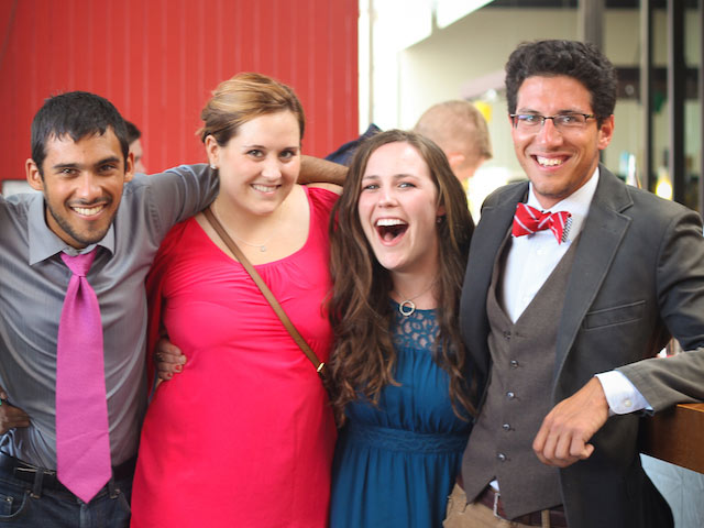 Four TEAN interns pose excitedly dressed up in nice clothes