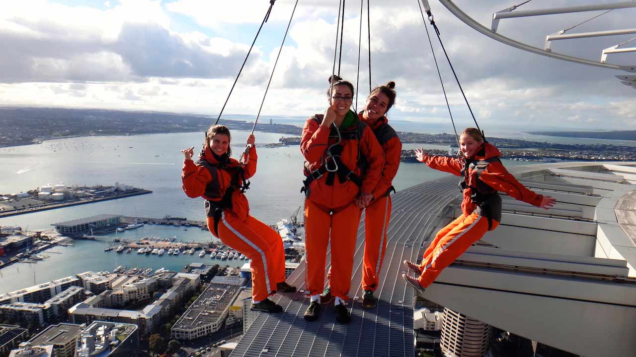 A group of women pose in excitement as they prepare to go bungee jumping off Auckland's Sky Tower