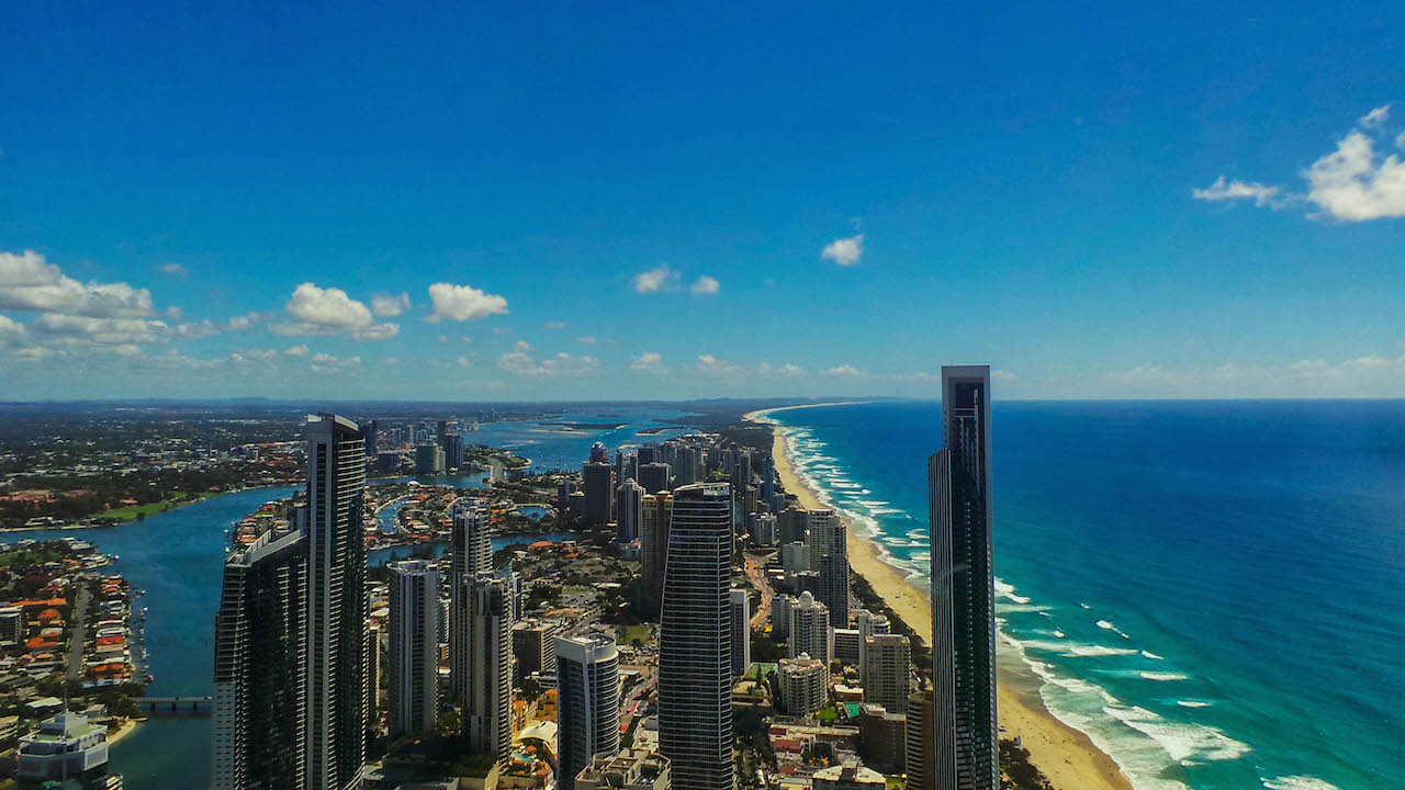 Gold Coast's buildings, beach, ocean and blue sky from above