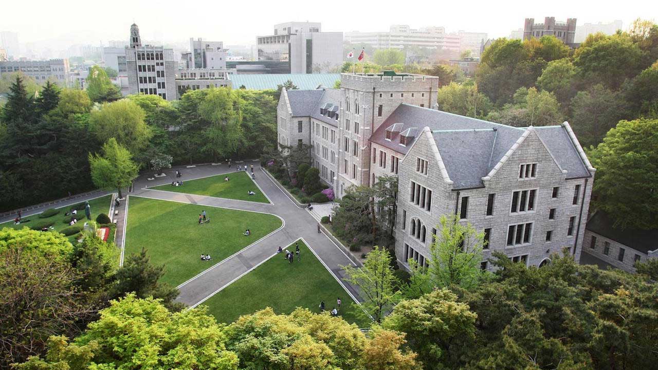 Korea University's main hall from above surrounded by greenery