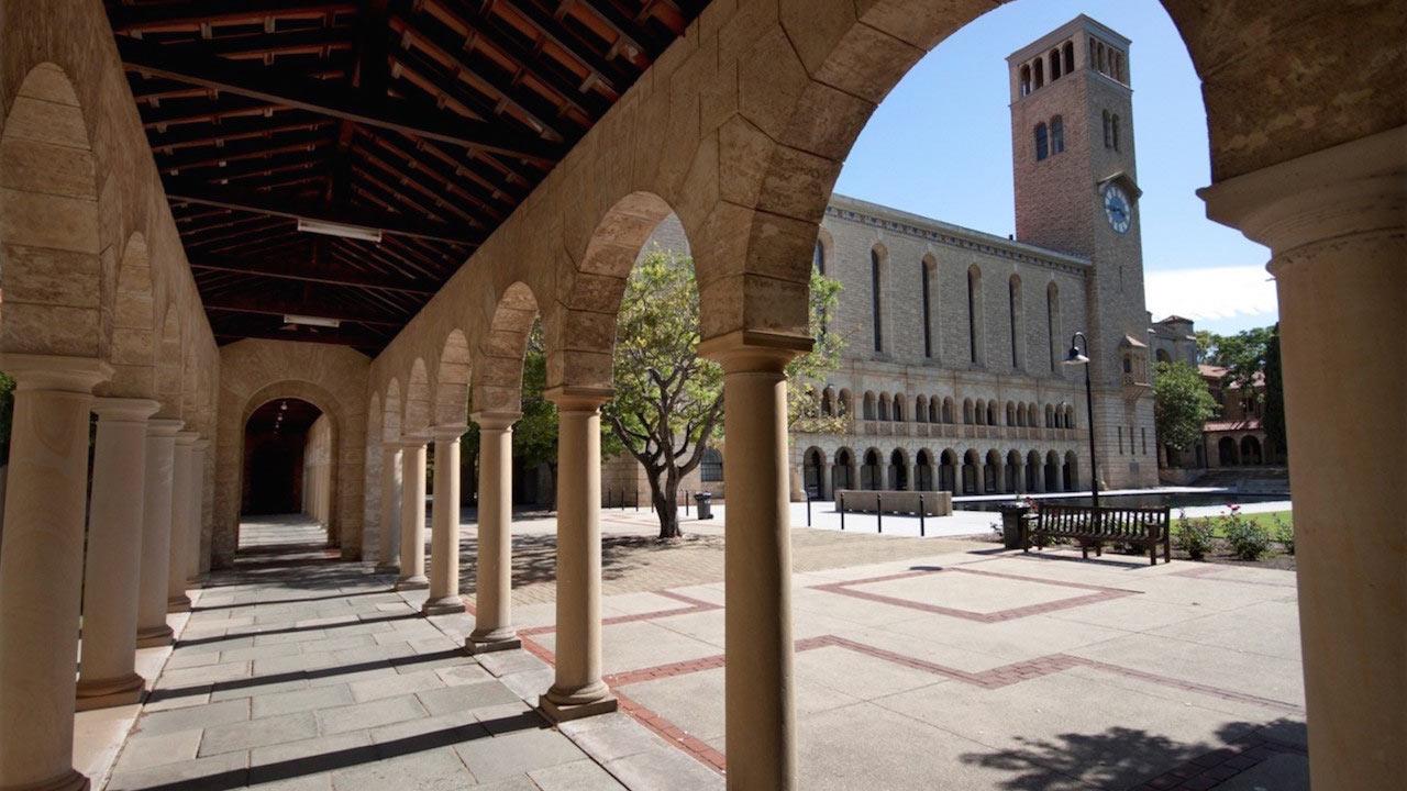 Pillars cast shadows in an open corridor on University of Western Australia's campus in Perth