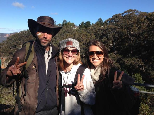 TEAN students and local guide together holding up peace signs amongst the Blue Mountains in Australia