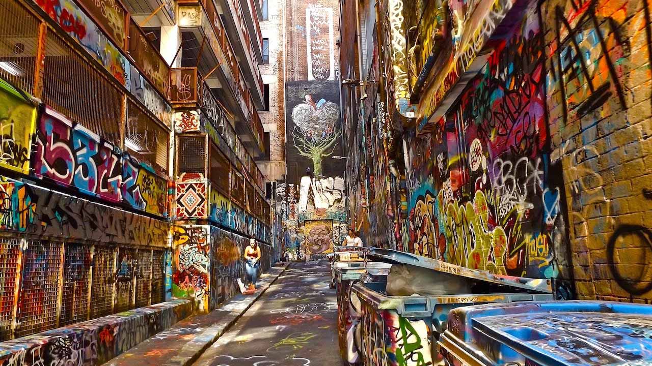 A laneway in Melbourne that is covered in colorful graffiti