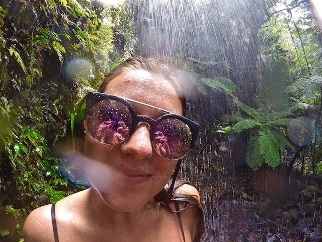 TEAN Student under a waterfall in Springbrook National Park